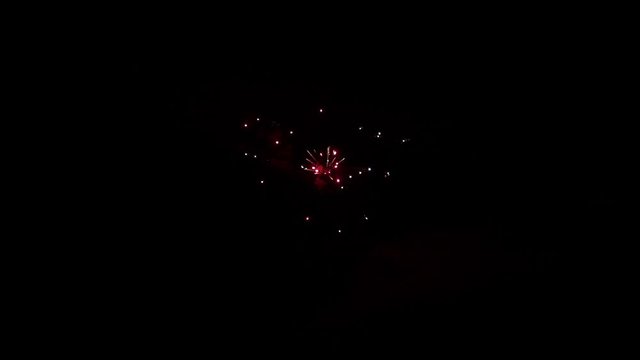 Explosion of bright colorful part of fireworks on black background to create a set salute on video for holiday new year, birthday, wedding or other celebration.