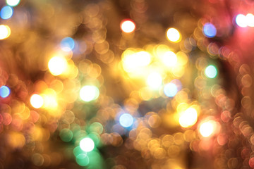 Abstract blurred background, trendy color - pink live coral. Blurred beautiful background of shiny light spots, bokeh. Blurred festive bright background for your design. banner