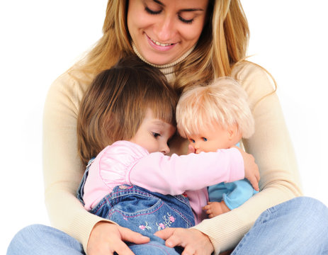 Happy mother embracing little daughter and her doll