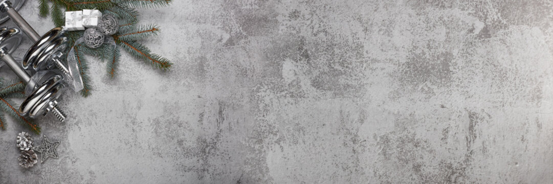 Dumbbells and Christmas decorations. Fitness.