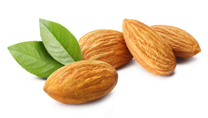 Obraz na płótnie Canvas Close-up of delicious almonds with leaves, isolated on white background