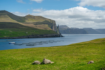 Fish farm aquaculture near Trollkonufingur, Witch's Finger, Fjord on Vagar island, Faroe Islands