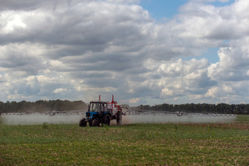 Fototapeta premium Ukraine, the tractor makes fertilizer