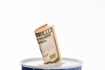 Can with US dollar bill sticking out of it