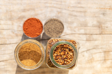 Two jars with spices of different grinding and two small bowls w