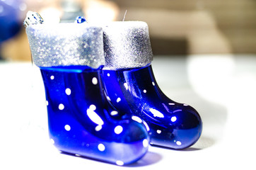 Blue boots decoration on the Christmas tree. Blue socks on a white background for the holiday.