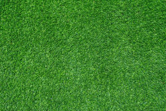 Texture of fake green grass for background or backdrop , Green soccer fake grass background texture