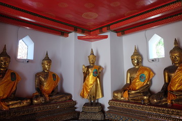Gilded statues of Buddha sitting in lotus position. Statues from a Buddhist monastery.