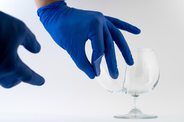 Hands in blue gloves fixing broken glass
