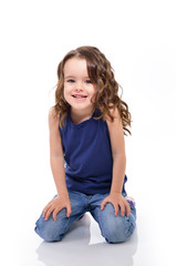 Little lovely girl smiling and looking at camera, studio shot over white background.