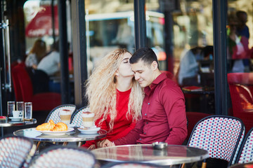 Beautiful romantic couple in Parisian outdoor cafe