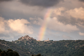 Rainbow over village of Sant'Antonino in Corsica