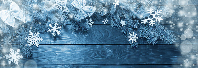 fir branches with Christmas decor on old dark wooden background