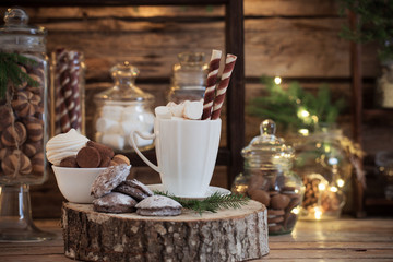 Christmas decoration cocoa bar with cookies and sweets on old wooden background in  natural rustic style. Winter cozy concept