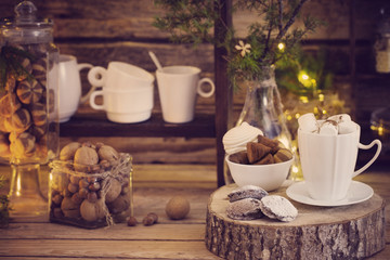 Christmas decoration cocoa bar with cookies and sweets on old wooden background in  natural rustic style. Winter cozy concept