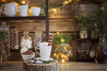 Christmas decoration cocoa bar with cookies and sweets on old wooden background in  natural rustic style. Winter cozy concept