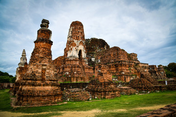 Ruins of Wat Mahathat, “the temple of the Great Relic” the most important temples in Ayutthaya province, Thailand which the architecture follows ancient Khmer mountain temples of Angkor in Cambodia.