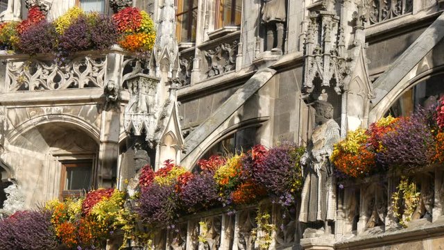 Munich, Germany - October 25, 2019: Part of the new town hall in Munich is decorated with a variety of blooming flowers. Marienplatz, the central square of the city
