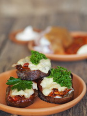 brown bread sandwiches with sun-dried tomatoes on a rustic wooden tableOLYMPUS DIGITAL CAMERA