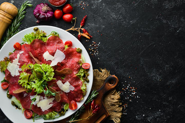Veal carpaccio. Veal with capers and parmesan cheese. Top view. Free copy space.