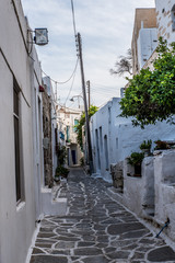 Fototapeta na wymiar Traditional small alleys at Parikia the port of Paros island, in Cyclades, Greece