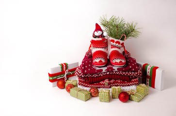 Little knitted boots with Christmas gifts and various decorations