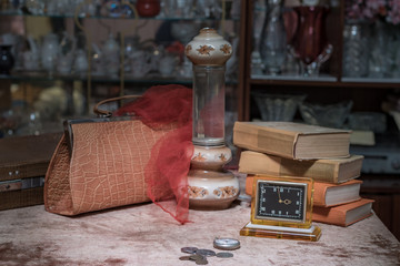 Retro still life with watches, lamp, books in the retro interior