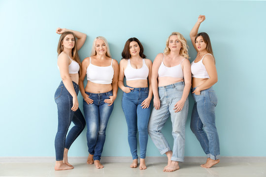 Group of body positive women near color wall