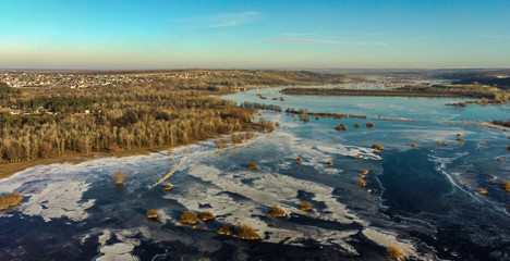 Aerial drone view above forzen river with small bush islands and Zhighuli hills in Samara region, Russia