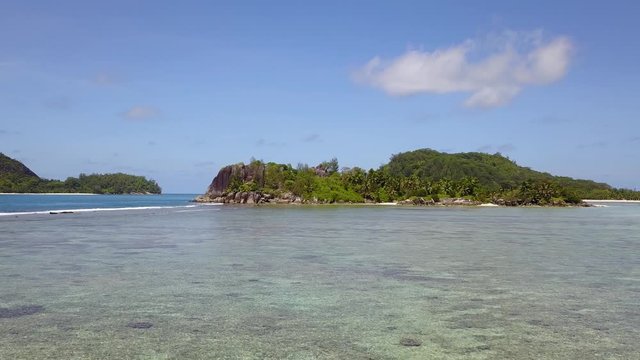 Camera goes wery close to water in direction to uninhabited island in Indian Ocean Seychelles 4K fantastic footage