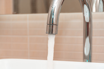Tap water flows from tap.