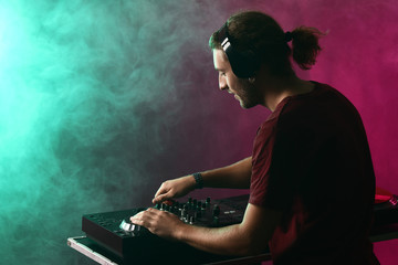 Male dj playing music in nightclub