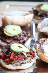 Homemade vegetable burger on white bun with avocado