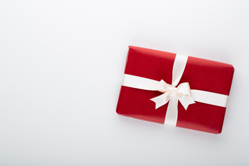 Gift or present box and stars confetti on color table top view. Flat lay composition for birthday, mother day or wedding.