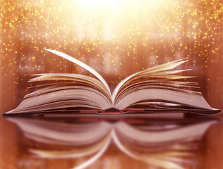  The blurred book that is bewitched with magic, the magic light in the dark, with the bright light shining down as the power to search for knowledge. For research and use as a blurred background
