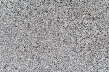Gray textured cement wall background with fine concrete chips. Construction backgrounds