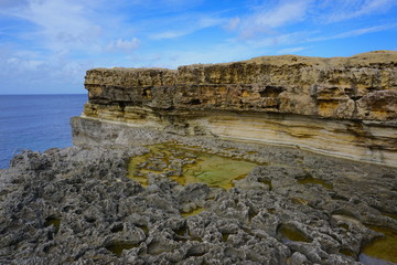 Rocks at the sea, rain water gathered at the rock hole, blue sky with small clouds, salt pans used to produce sea salt, beautiful walking path at the Salinas/ salt pans. 