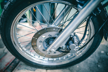 Fototapeta na wymiar Close up view on wheel and spokes of motorcycle