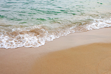Fototapeta na wymiar Beautiful white sand beach by the sea, clear blue sky and soft waves.