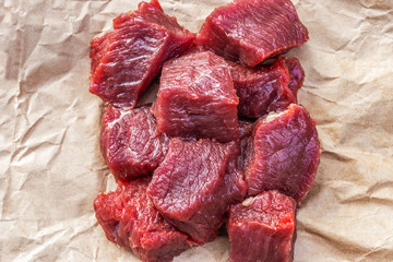 A lot of small pieces of raw beef meat on food paper