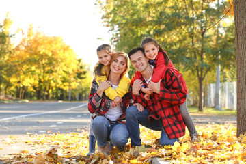 Portrait of happy family in autumn park