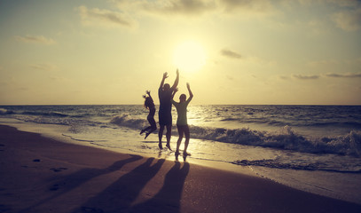 Father with two kids enjoying summer vacation on the beach