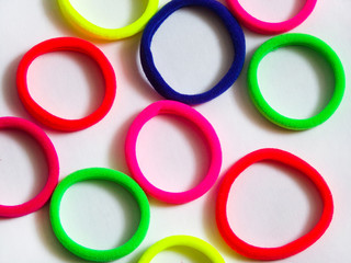 Original background of colorful rings. Hair bands close up.