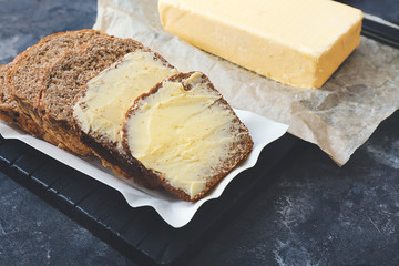 Tasty fresh bread with butter on table