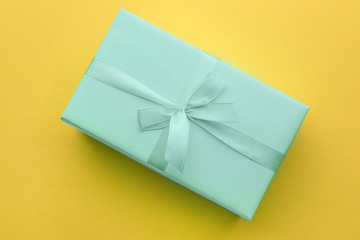 Turquoise gift box on color background
