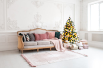 Blurred photo of modern living room with Christmas tree and sofa inside