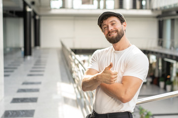 man with visor on the head look at camera and raise thumb up