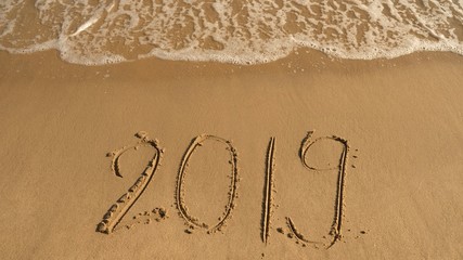 2019 word written in sand on the beach