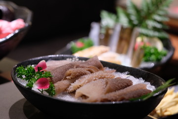 Close up fresh tripes in plate. Raw food for hot pot. Blurred background