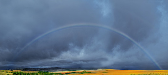 Castilla-la Mancha, Spain: 11.03.2019; The spectacular entire rainbow above the ground